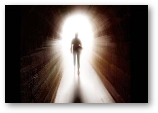 Silhouette of a man walking into light